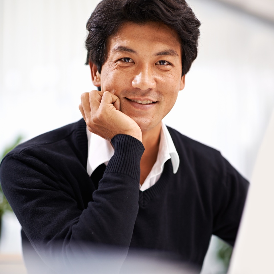 Smile, businessman and portrait of employee with laptop on desk working with internet online. Adult, Asian male person and staff in corporate company to research on website and social media