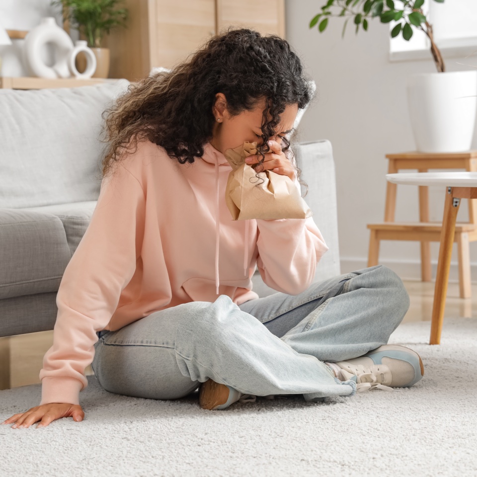 Young African-American woman having panic attack at home